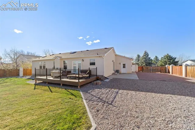 a view of a patio with chairs and potted plants