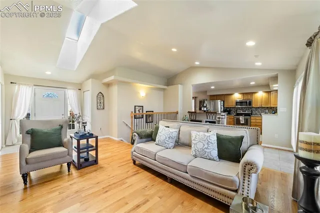 a living room with furniture and view of kitchen