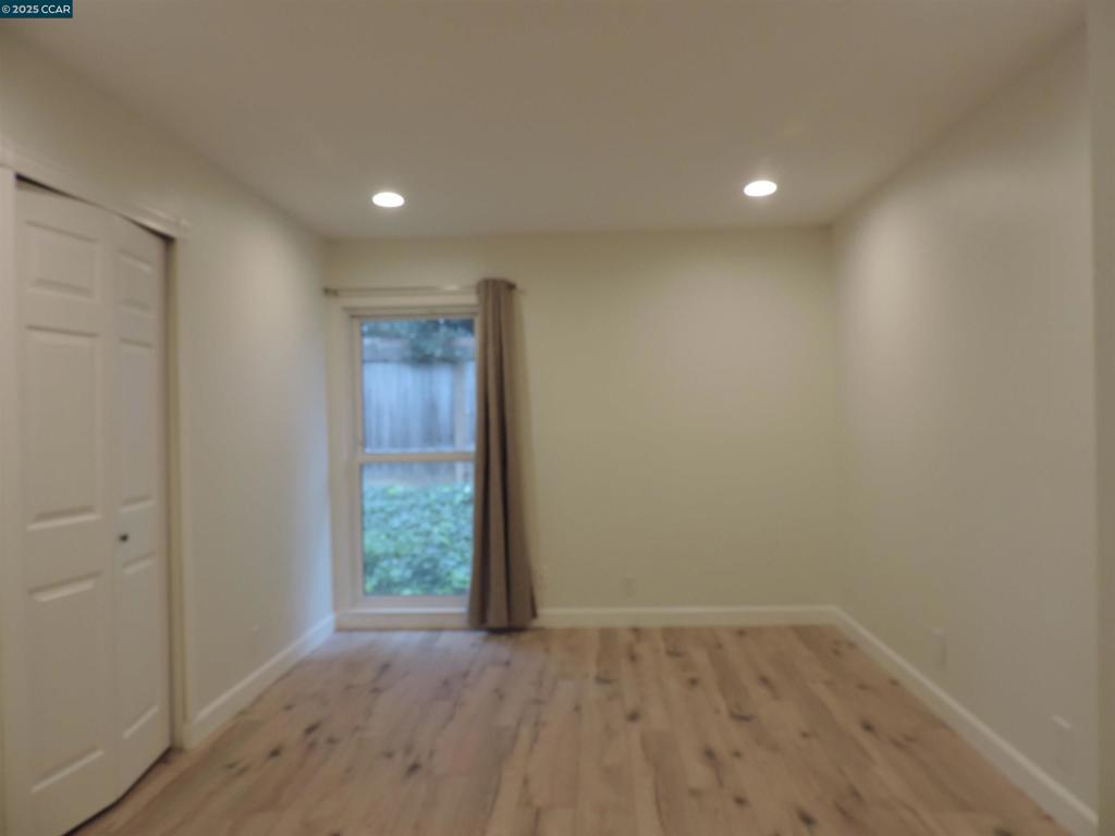 1919 Ygnacio Valley Road Walnut Creek, CA 94598 - Photo 12 of 35 a view of an empty room with wooden floor and a window