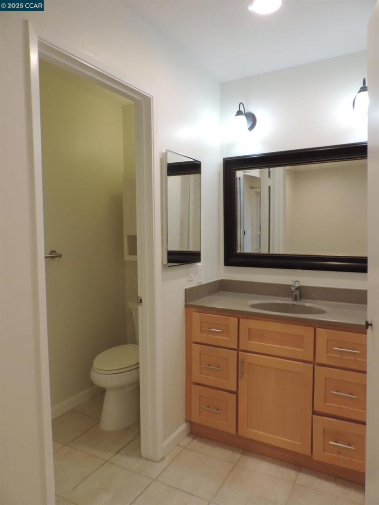 1919 Ygnacio Valley Road Walnut Creek, CA 94598 - Photo 13 of 35 a bathroom with a toilet a sink and mirror