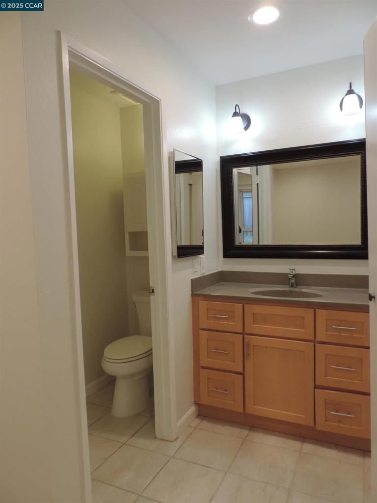 1919 Ygnacio Valley Road Walnut Creek, CA 94598 - Photo 14 of 35 a bathroom with a sink a toilet and mirror