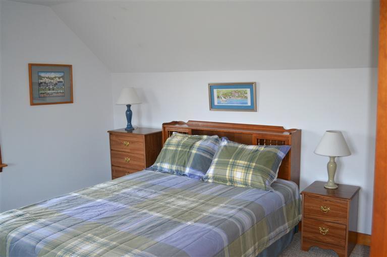 460 Summit Avenue Eastham, MA 02642 - Photo 12 of 25 a bedroom with a bed and wooden floor