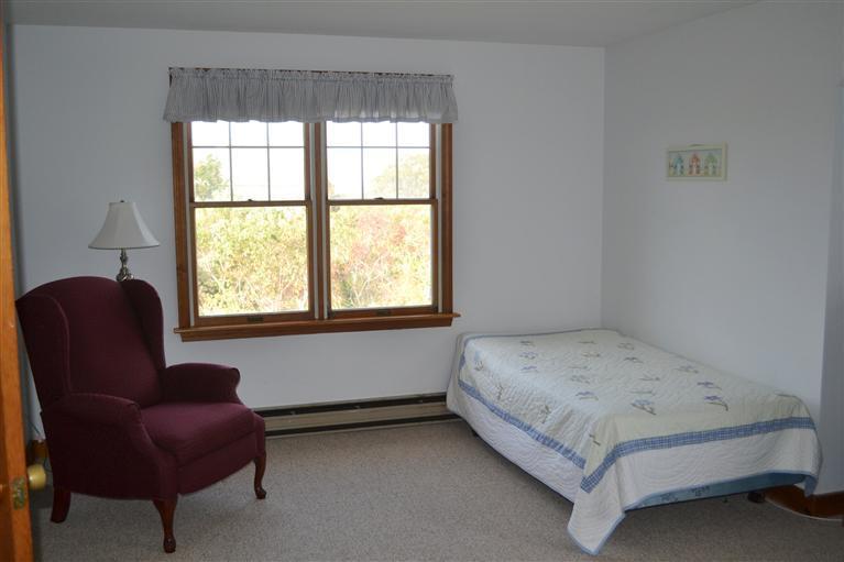 460 Summit Avenue Eastham, MA 02642 - Photo 13 of 25 a bedroom with a bed and a chair