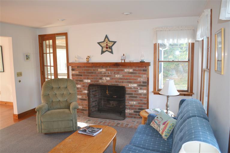 460 Summit Avenue Eastham, MA 02642 - Photo 3 of 25 a living room with furniture and a fireplace