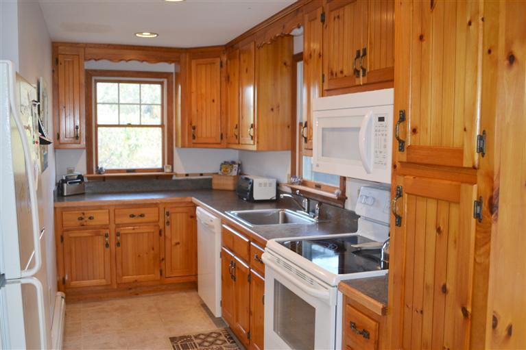460 Summit Avenue Eastham, MA 02642 - Photo 6 of 25 a kitchen with stainless steel appliances granite countertop a sink stove and refrigerator