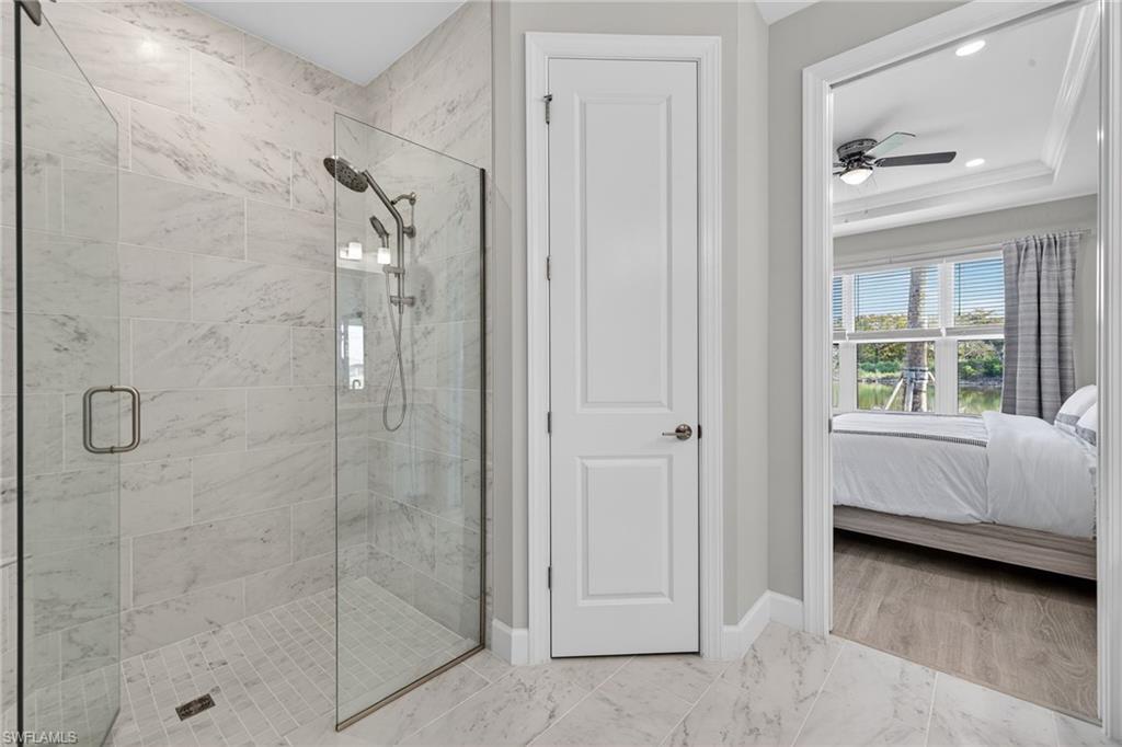 15641 Gavello Street Naples, FL 34114 - Photo 17 of 37 a bathroom with a tub and shower