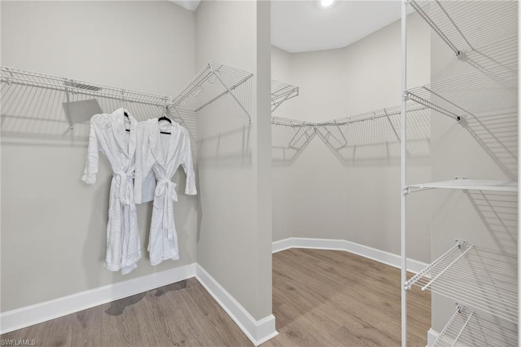 15641 Gavello Street Naples, FL 34114 - Photo 19 of 37 a view of walk in closet with empty racks