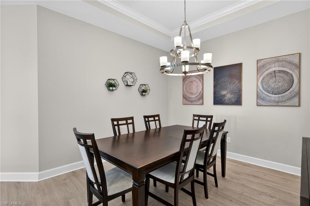15641 Gavello Street Naples, FL 34114 - Photo 21 of 37 a view of a dining room with furniture and wooden floor