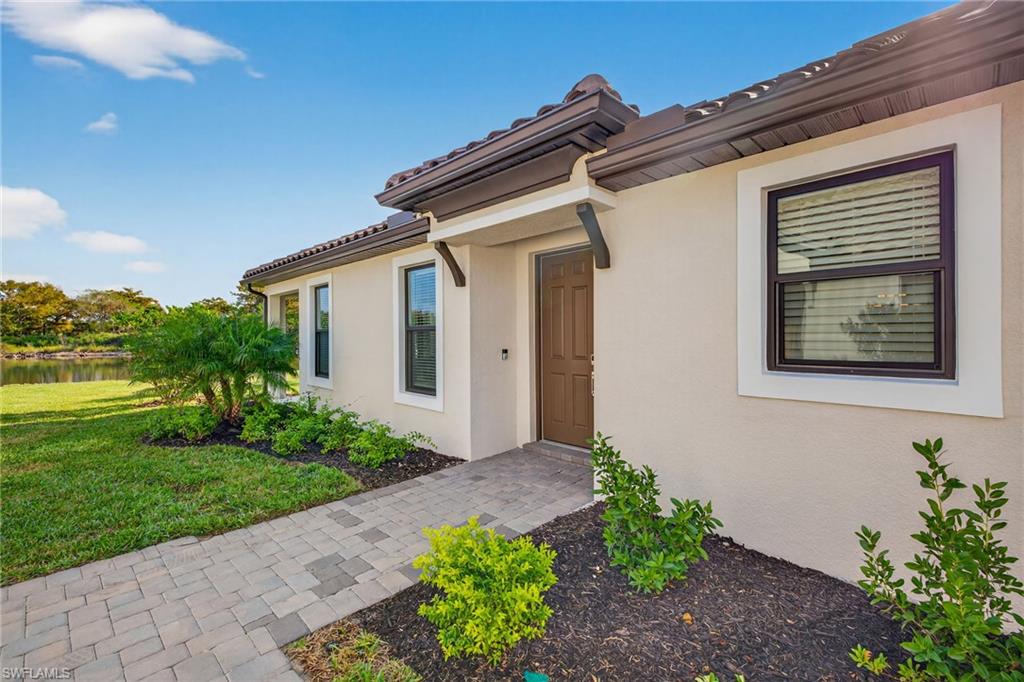 15641 Gavello Street Naples, FL 34114 - Photo 3 of 37 a view of a house with a yard