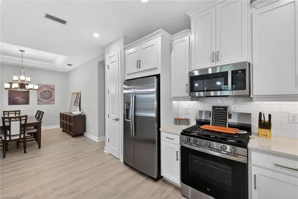 a kitchen with stainless steel appliances a stove a microwave and a refrigerator