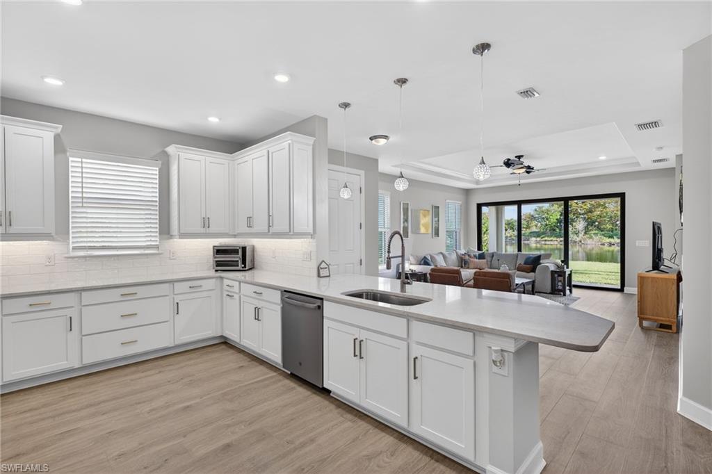 15641 Gavello Street Naples, FL 34114 - Photo 9 of 37 a kitchen with sink refrigerator and window