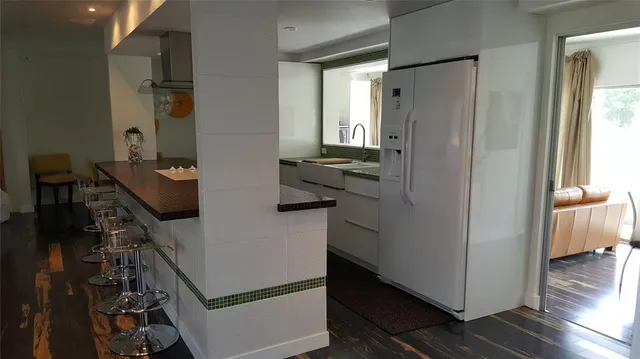 a kitchen with a refrigerator and a stove top oven