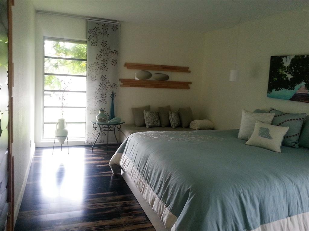 7108 Northwest 66th Street Tamarac, FL 33321 - Photo 14 of 23 a bedroom with a bed and wooden floor