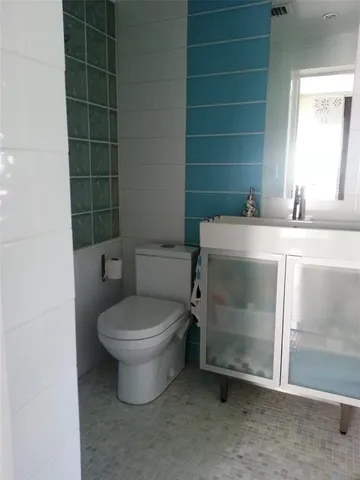 a bathroom with a toilet and a sink