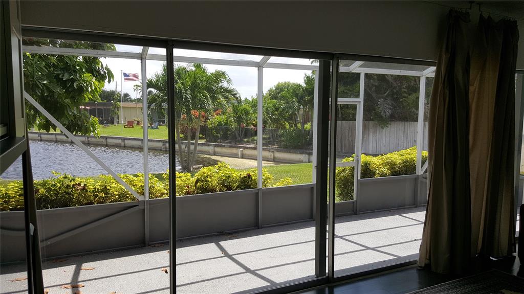 7108 Northwest 66th Street Tamarac, FL 33321 - Photo 17 of 23 a view of a glass door with a porch