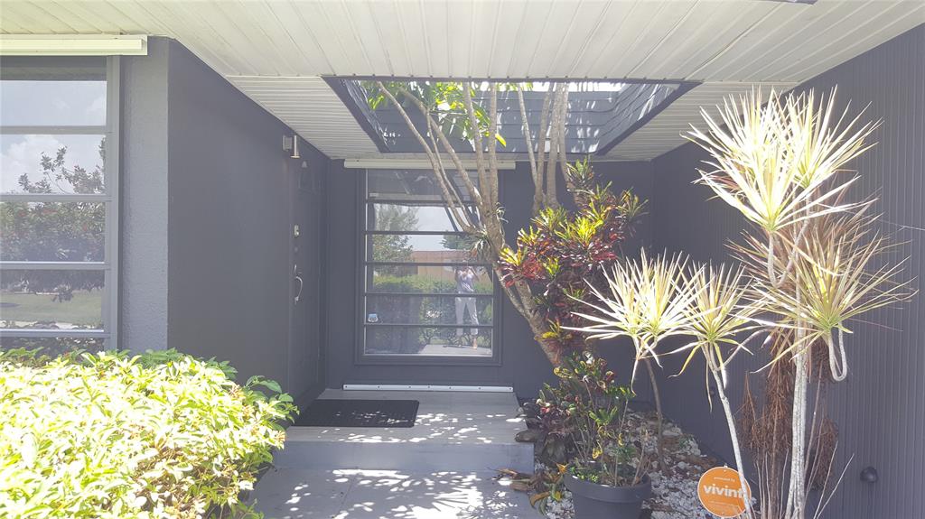 7108 Northwest 66th Street Tamarac, FL 33321 - Photo 20 of 23 a vase of flowers sitting on a table