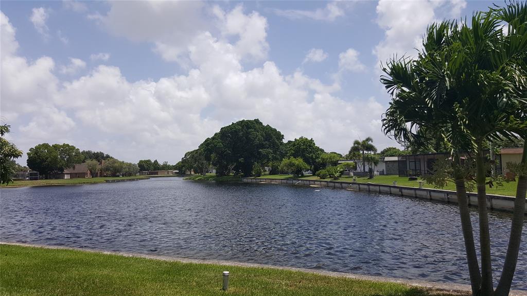 7108 Northwest 66th Street Tamarac, FL 33321 - Photo 22 of 23 a view of a lake with a big yard