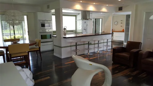 a kitchen with stainless steel appliances kitchen island granite countertop a sink and cabinets