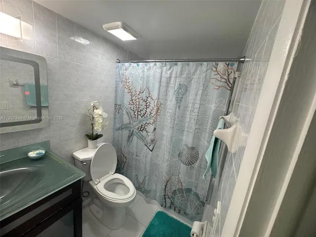 a white toilet sitting next to a bathroom sink