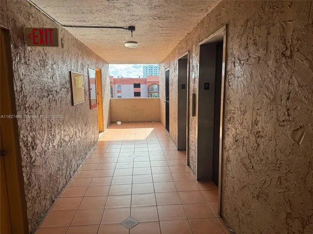 a view of a patio with a table and chairs