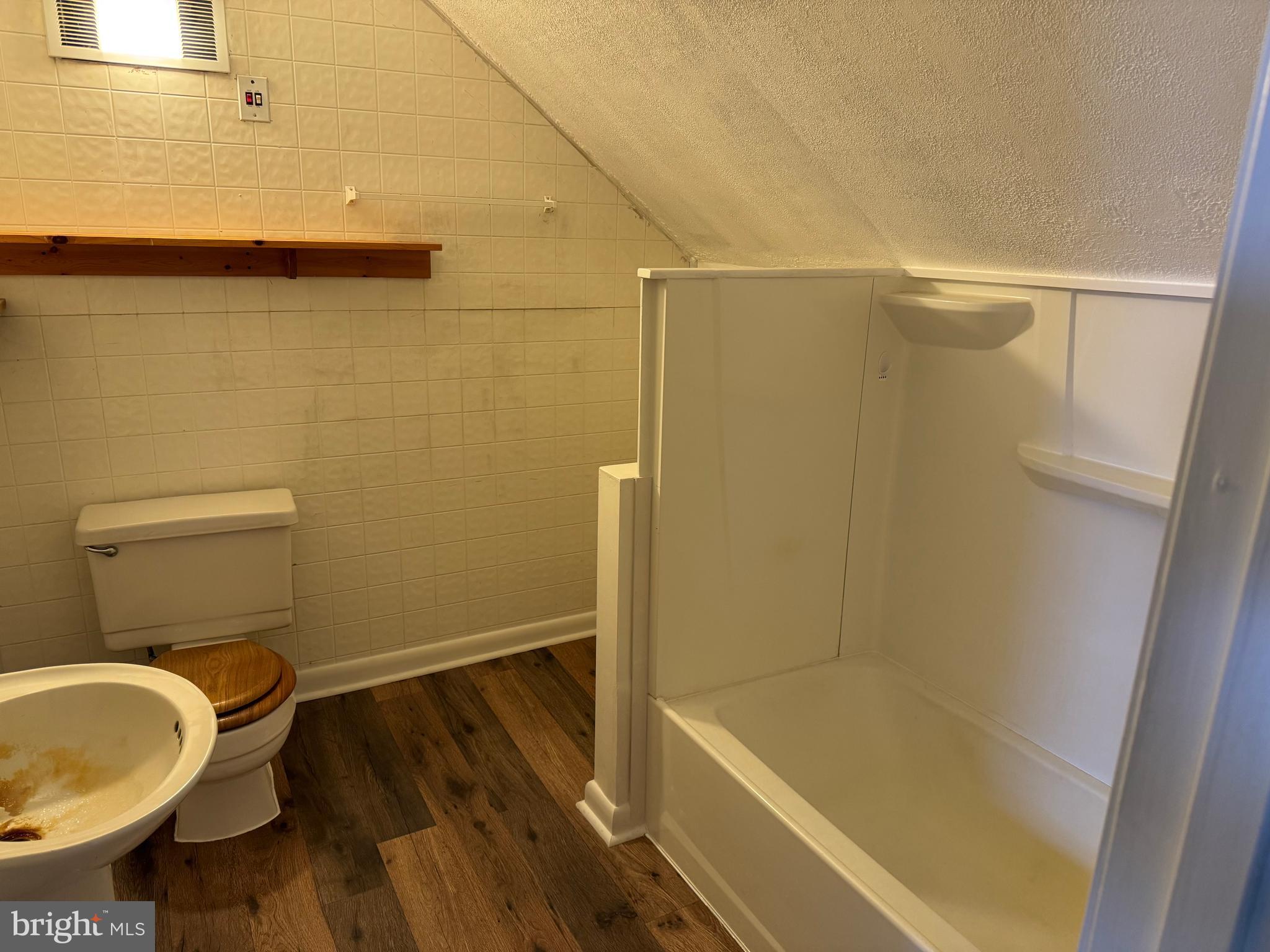 3959 Warm Spring Road Chambersburg, PA 17202 - Photo 13 of 13 a bathroom with a granite countertop bathtub shower sink and toilet