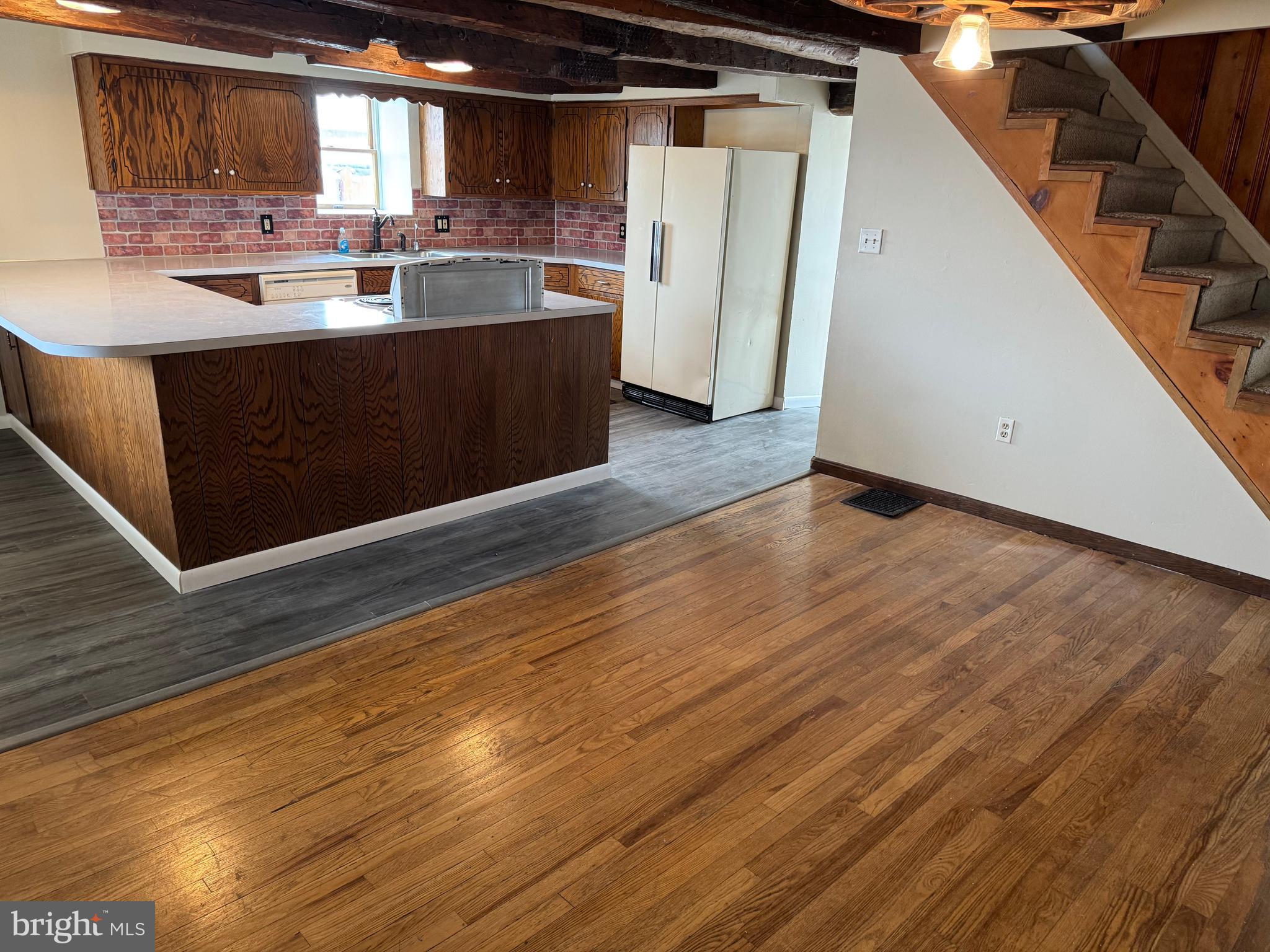 3959 Warm Spring Road Chambersburg, PA 17202 - Photo 2 of 13 a kitchen with stainless steel appliances wooden floor sink and wooden cabinets