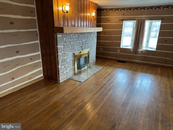 a view of fireplace and wooden floor