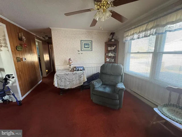 a bedroom with a bed and a couch next to a window