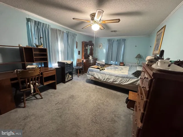a view of a livingroom with furniture and staircase