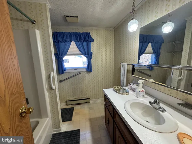 a view of a room with furniture and a chandelier