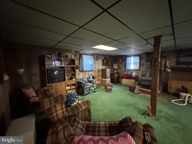 a living room with furniture a rug and a fireplace