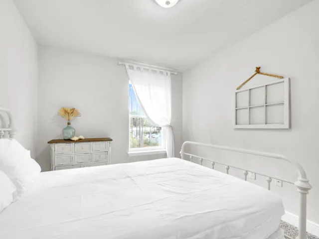 a bedroom with a large bed and a window