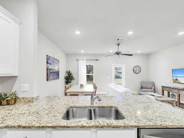 a living room with granite countertop kitchen island furniture and a kitchen view