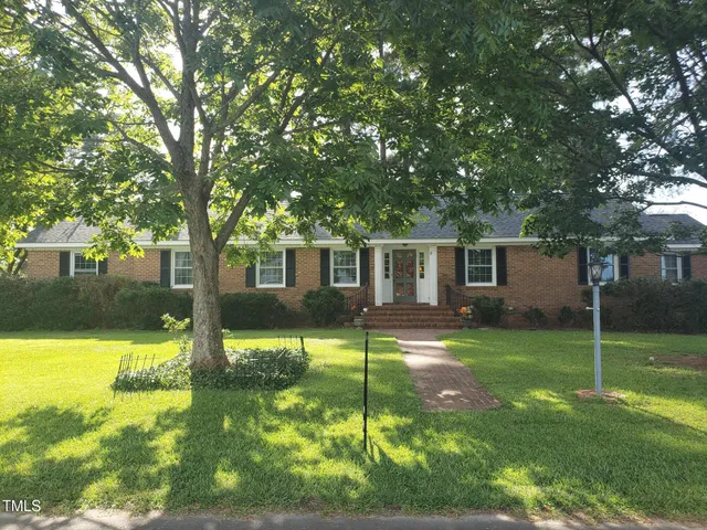 a view of a house with a yard porch and sitting area