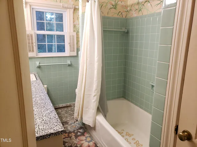 a kitchen with stainless steel appliances granite countertop a refrigerator a sink dishwasher a stove with wooden cabinets and wooden floor