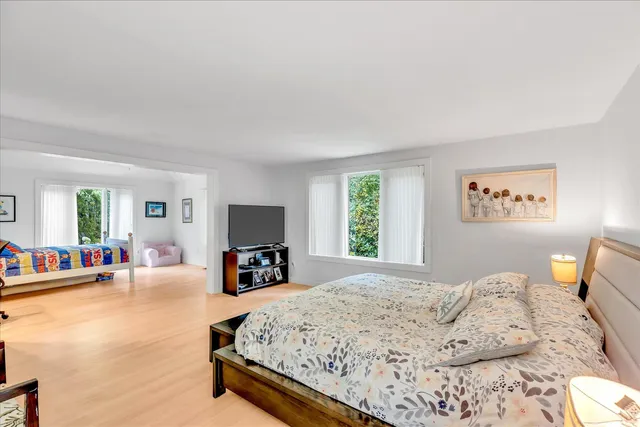 a bedroom with a large bed and a couch