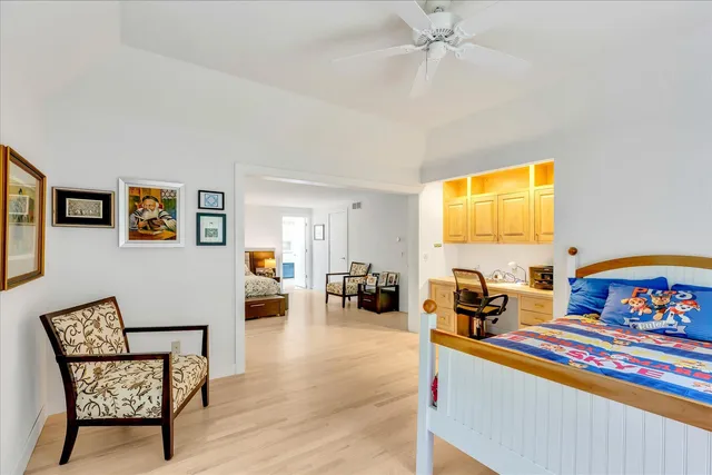 a bedroom with furniture and a large window