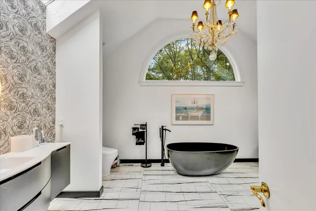 a view of a room with wooden floor and a potted plant