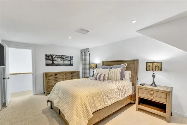 a bedroom with a bed and a night stand