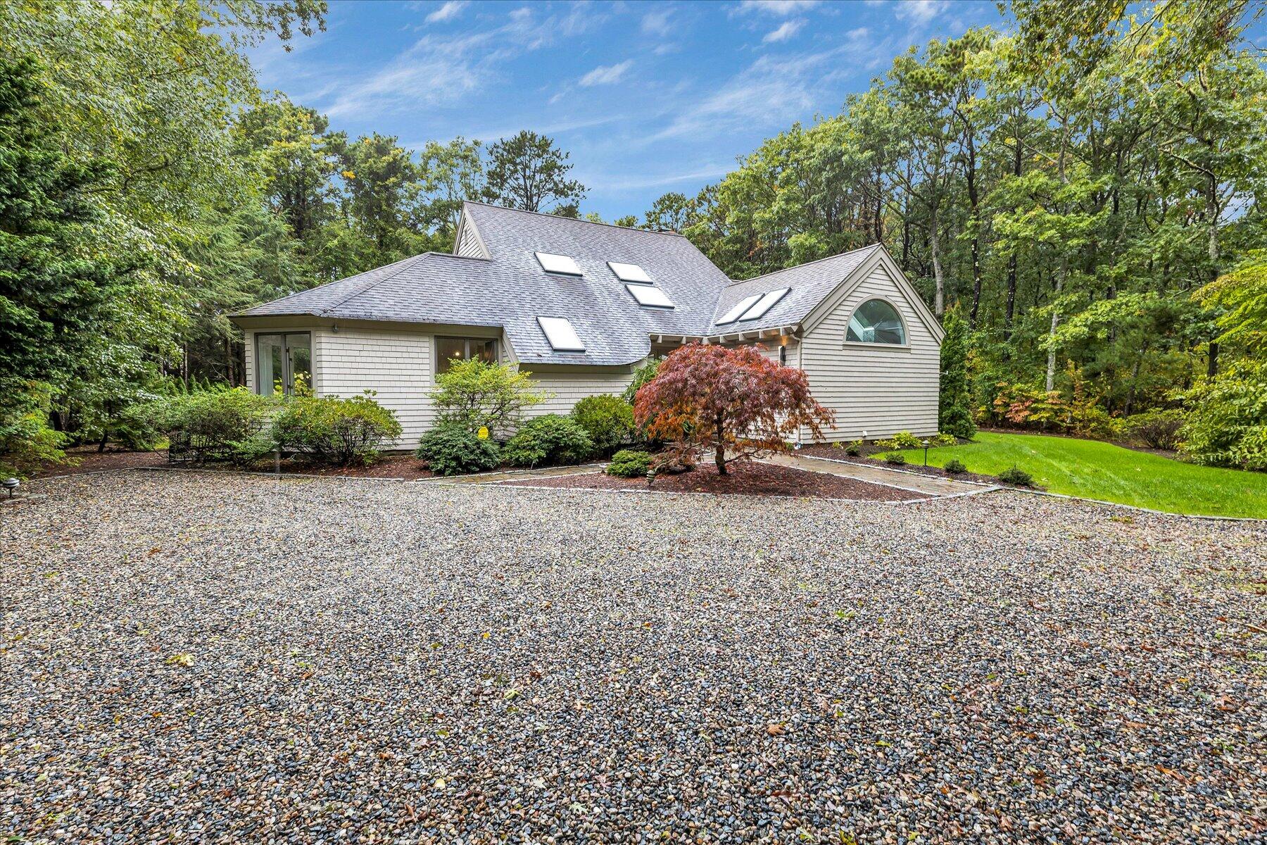 50 Topping Lift Mashpee, MA 02649 - Photo 2 of 32 a front view of a house with a yard and garage