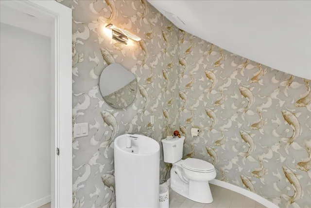 a white toilet sitting next to a shower curtain