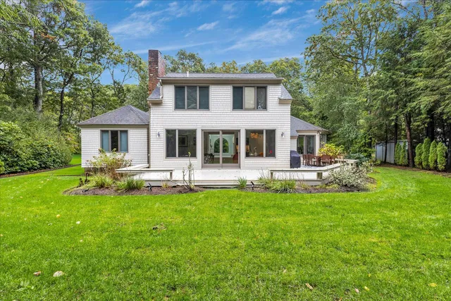 a view of a house with a yard porch and sitting area