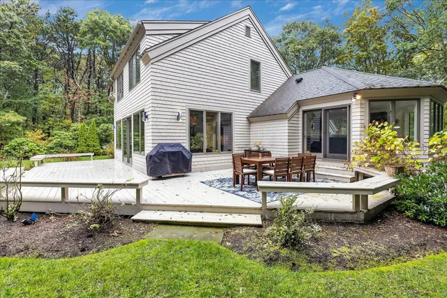 a view of a house with backyard and sitting area