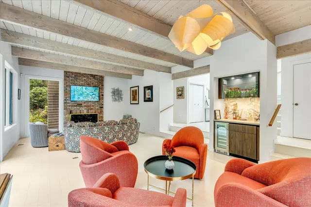 a living room with furniture a flat screen tv and a large window