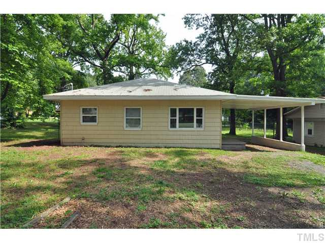 1705 Cheek Road Durham, NC 27704 - Photo 23 of 25 a backyard of a house with potted plants and large tree