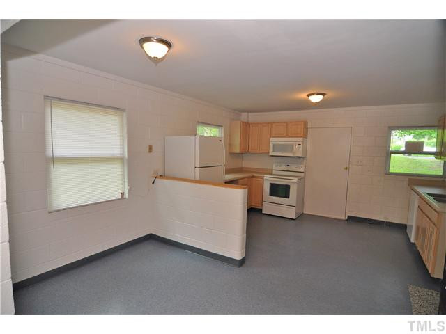 1705 Cheek Road Durham, NC 27704 - Photo 5 of 25 a kitchen with a refrigerator and a stove top oven