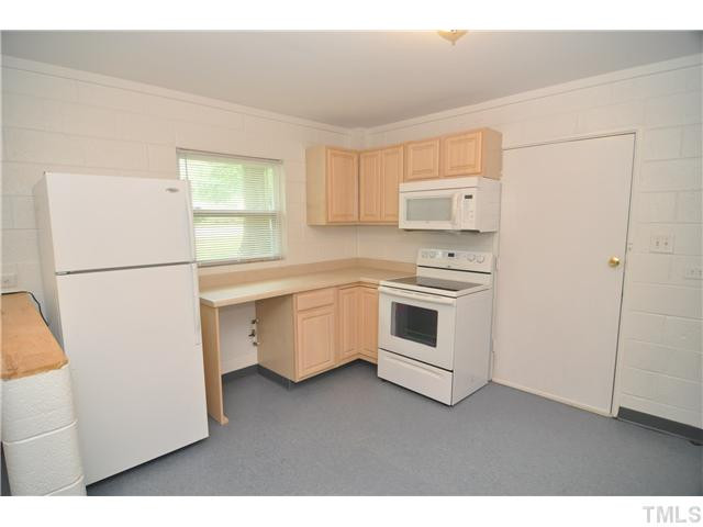 1705 Cheek Road Durham, NC 27704 - Photo 8 of 25 a kitchen with white cabinets and white appliances