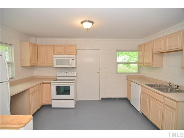 1705 Cheek Road Durham, NC 27704 - Photo 9 of 25 a kitchen with a sink stove and cabinets