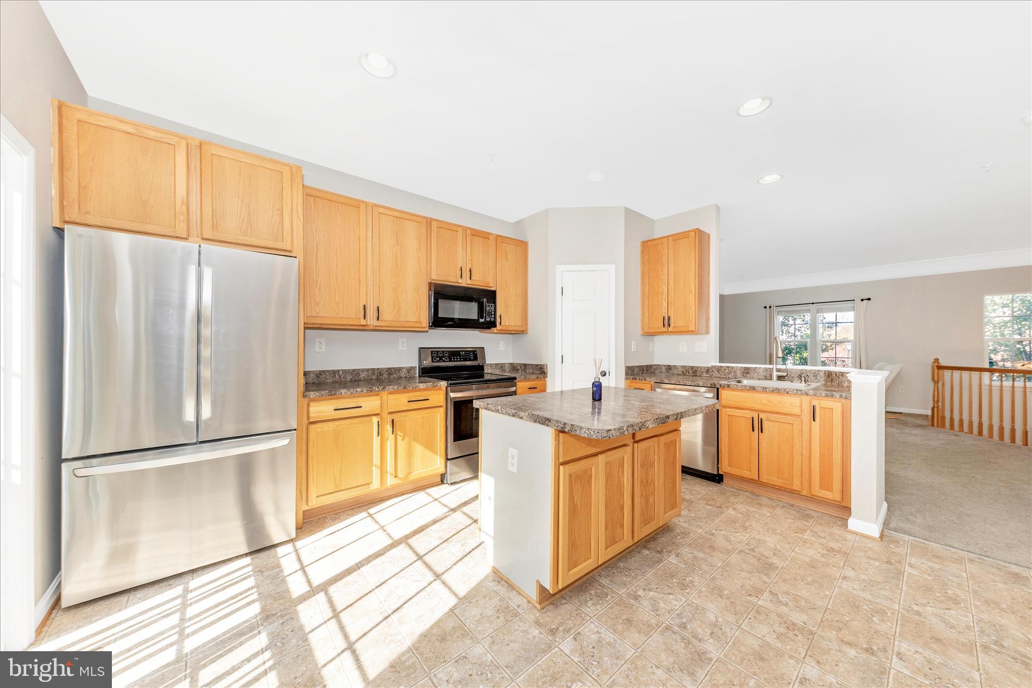 1812 Reading Court Mount Airy, MD 21771 - Photo 12 of 43 a kitchen with white cabinets and stainless steel appliances