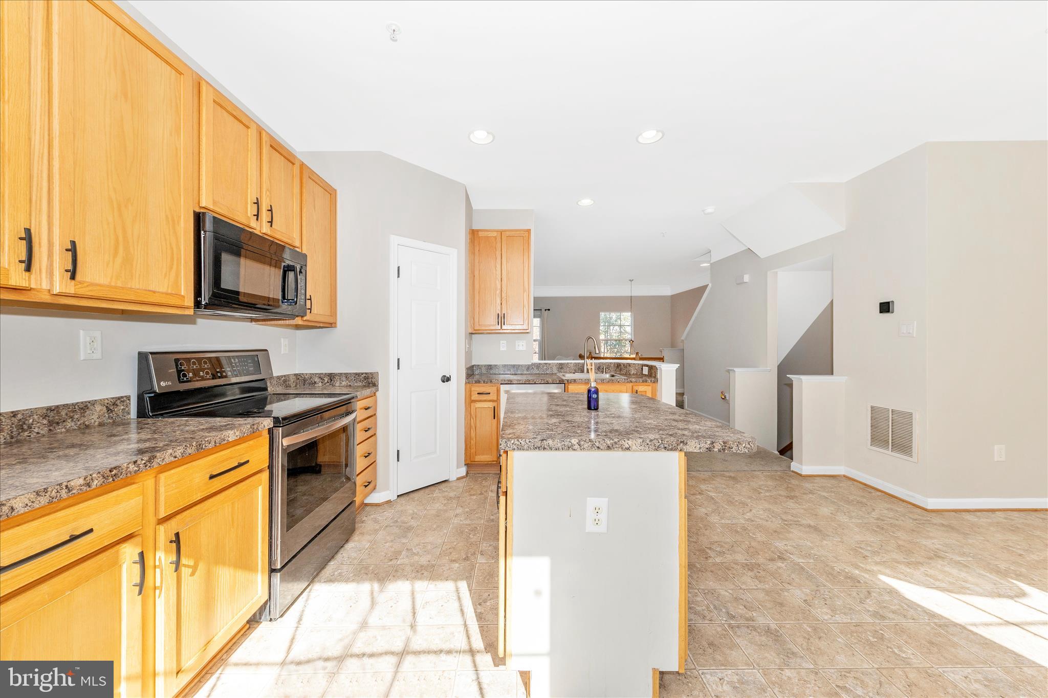 1812 Reading Court Mount Airy, MD 21771 - Photo 13 of 43 a kitchen with stainless steel appliances granite countertop a stove a sink and a microwave